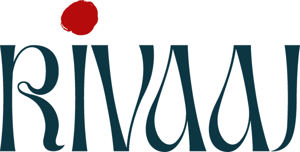 Logo of the brand 'RIVAU' with a red dot above the text on a white background.